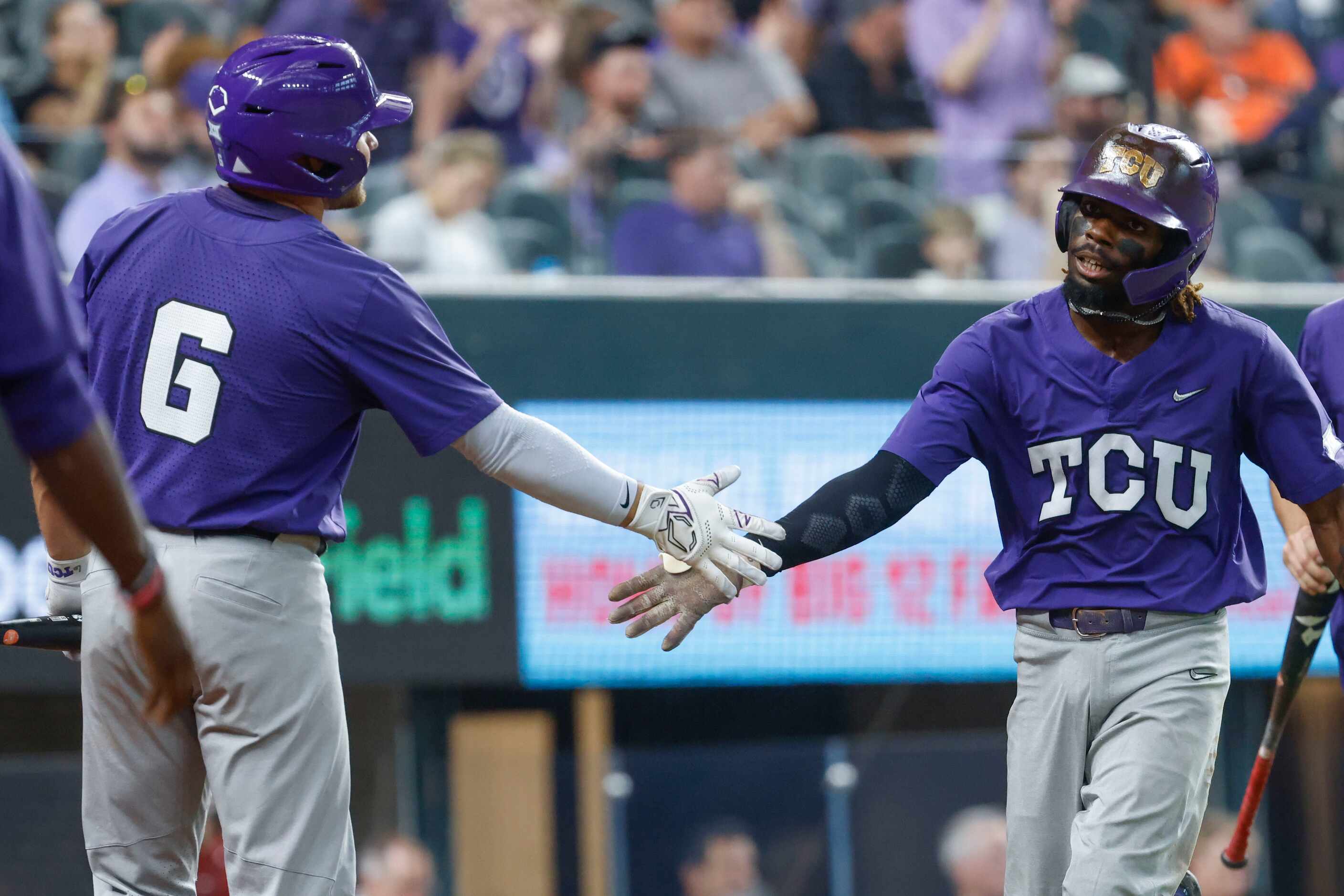 TCU infielder Tre Richardson cheers with this teammates after he doubles two runs during the...