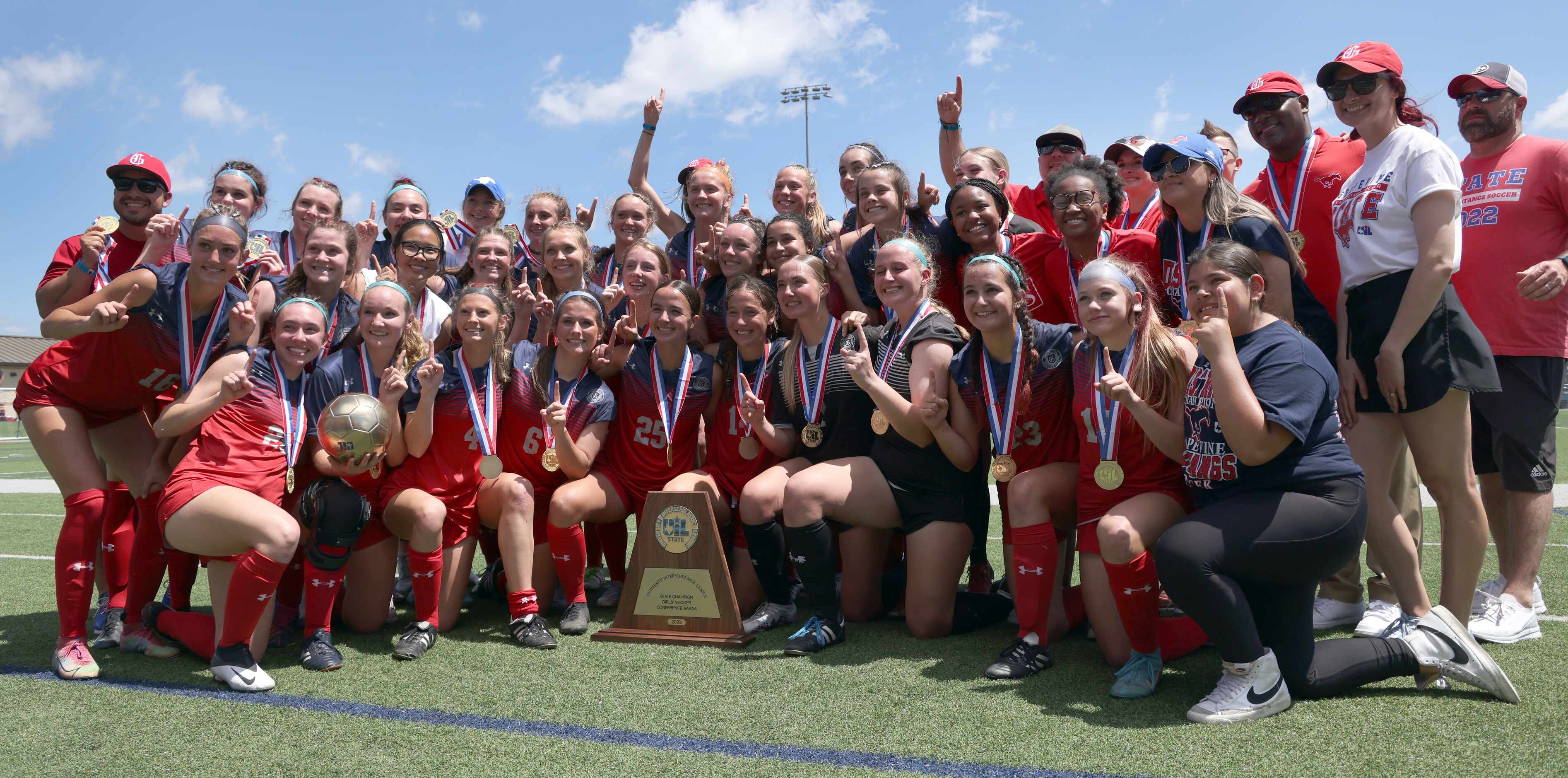 Grapevine players and coaches pose with the Class 5A state championship trophy following...