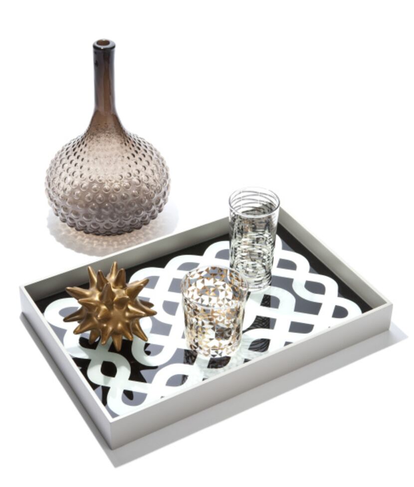 DwellStudio by Global Views glass vase, $63, lacquered wood “Labyrinth” tray, $148, ceramic...