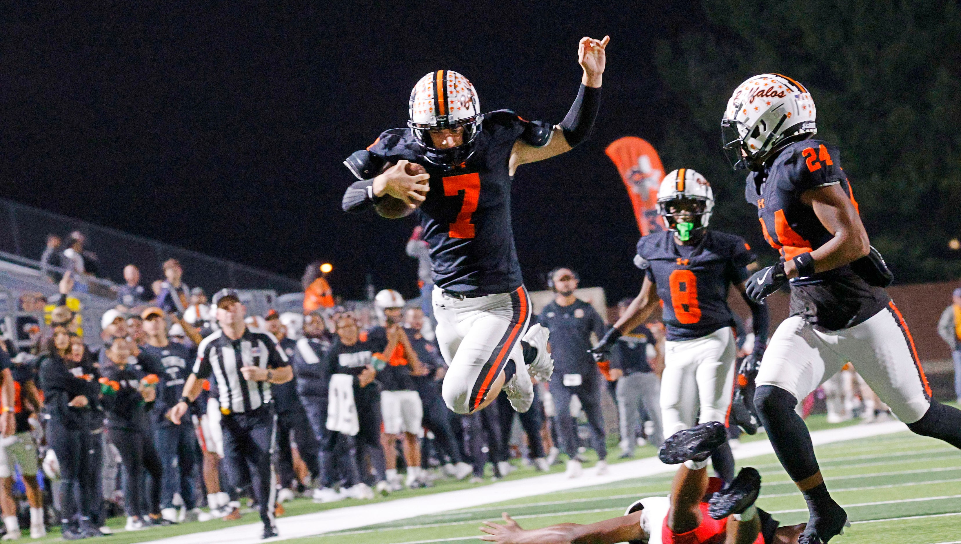 Haltom's Brian Connors (7) jumps over a Sam Houston player as his teammates Amaree Jackson...