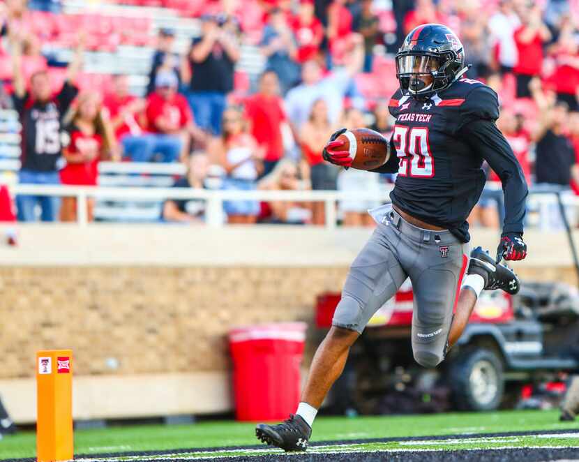 Texas Tech's Adrian Frye (20) returns an interception for a touchdown during an NCAA college...