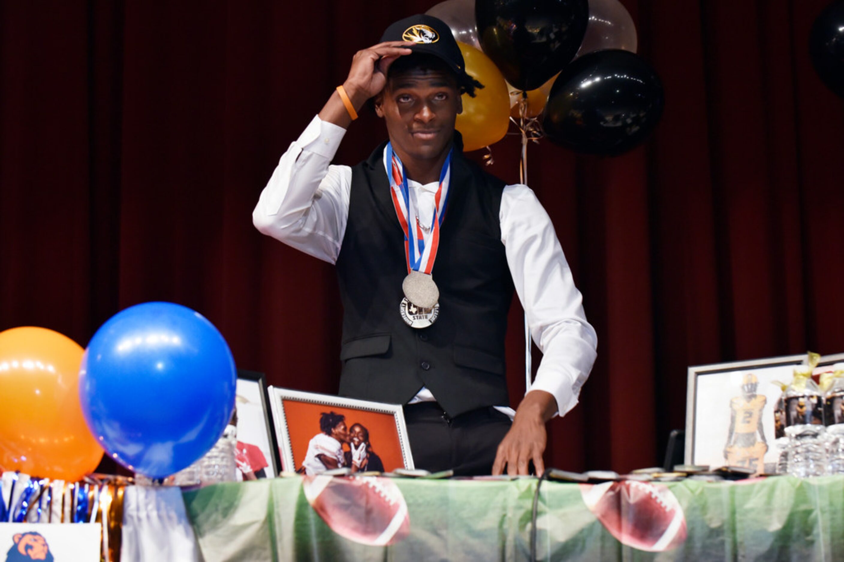 Duncanville cornerback Ennis Rakestraw, Jr., places a Missouri cap on his head revealing he...