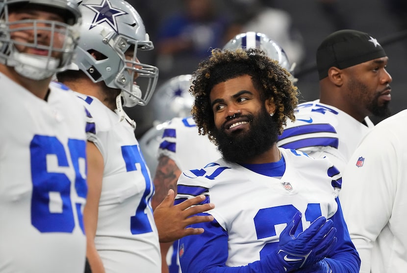 Dallas Cowboys running back Ezekiel Elliott (21) laughs with offensive guard Zack Martin...