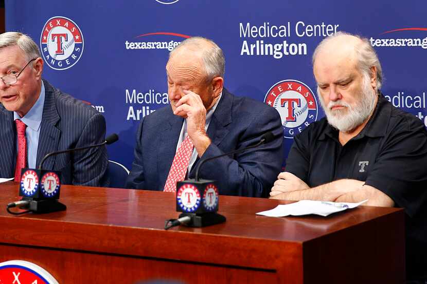 Texas Rangers Chief Executive Officer Nolan Ryan wipes his eye after announcing his...