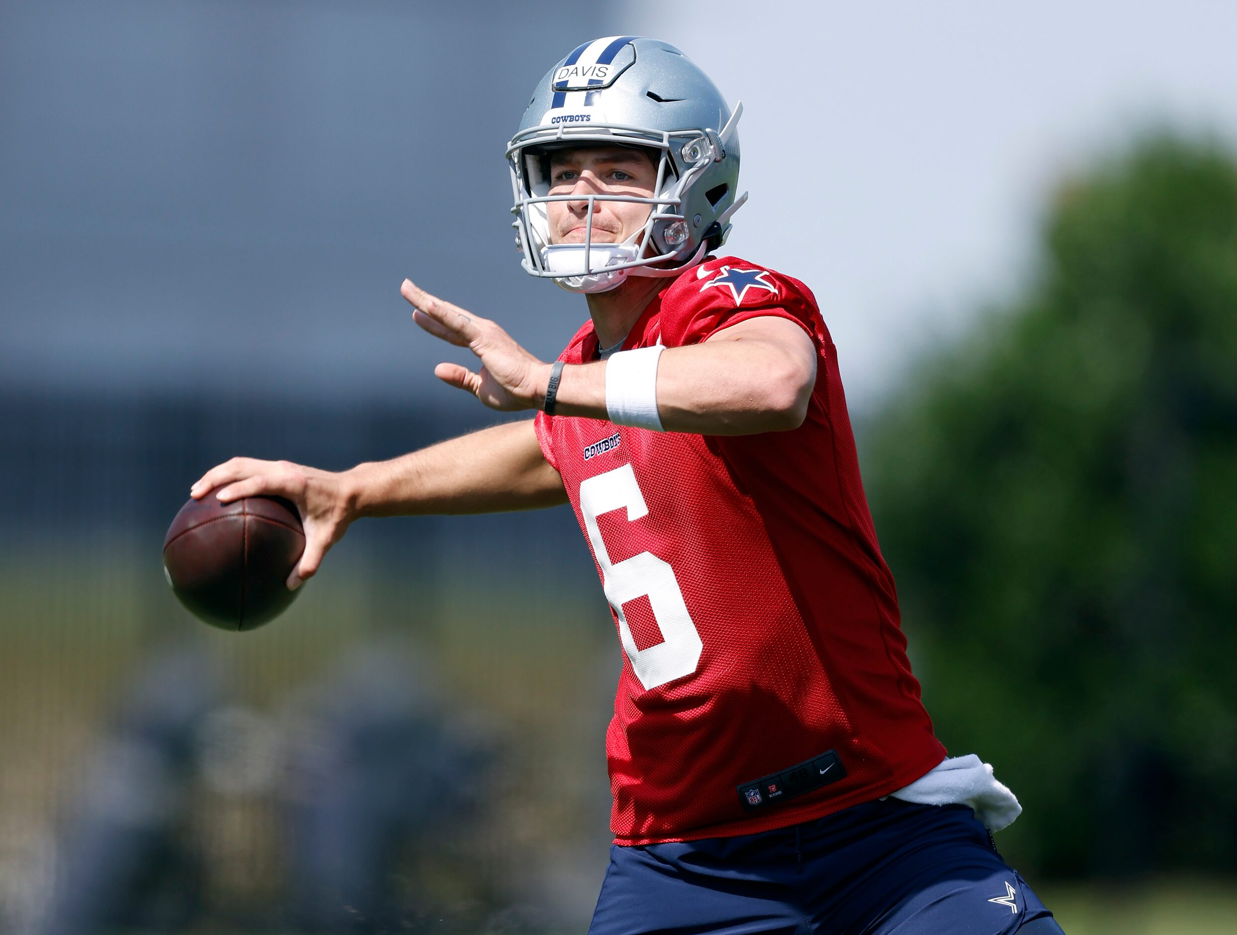 Dallas Cowboys rookie quarterback Brady Davis (6) throws o the run during rookie minicamp at...