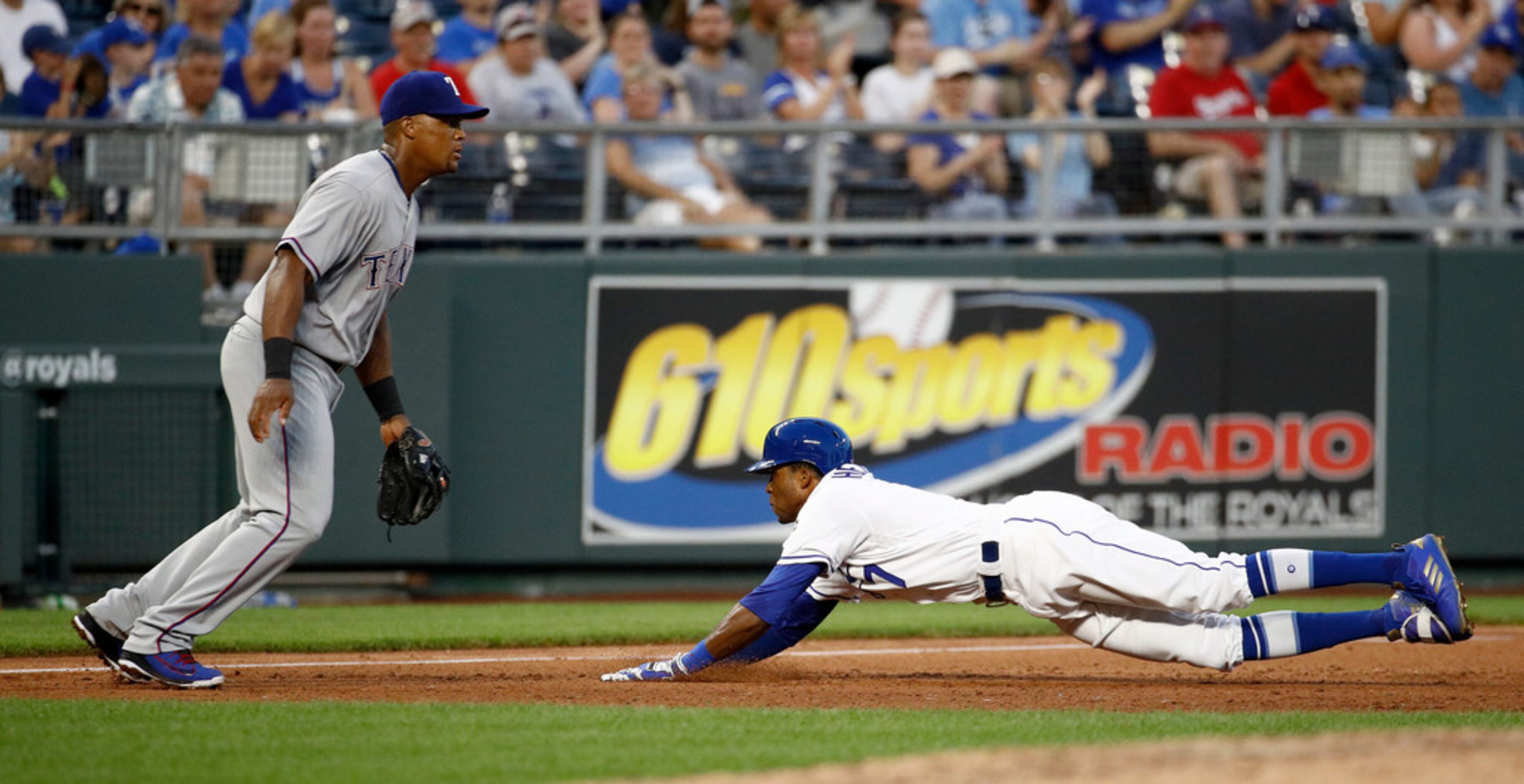 Kansas City Royals' Rosell Herrera beats the tag by Texas Rangers third baseman Adrian...