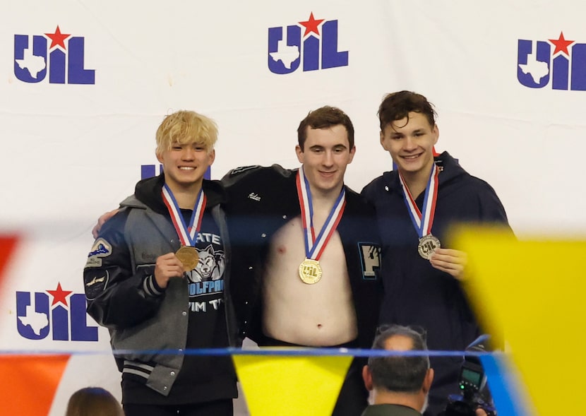 Frisco Panther Creek Aidan Eckard,center, poses after his winning performance in boys 100...