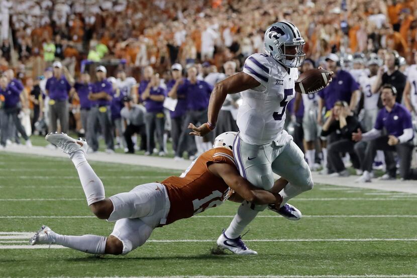FILE - In this Oct. 7, 2017, file photo, Kansas State quarterback Alex Delton (5) is stopped...