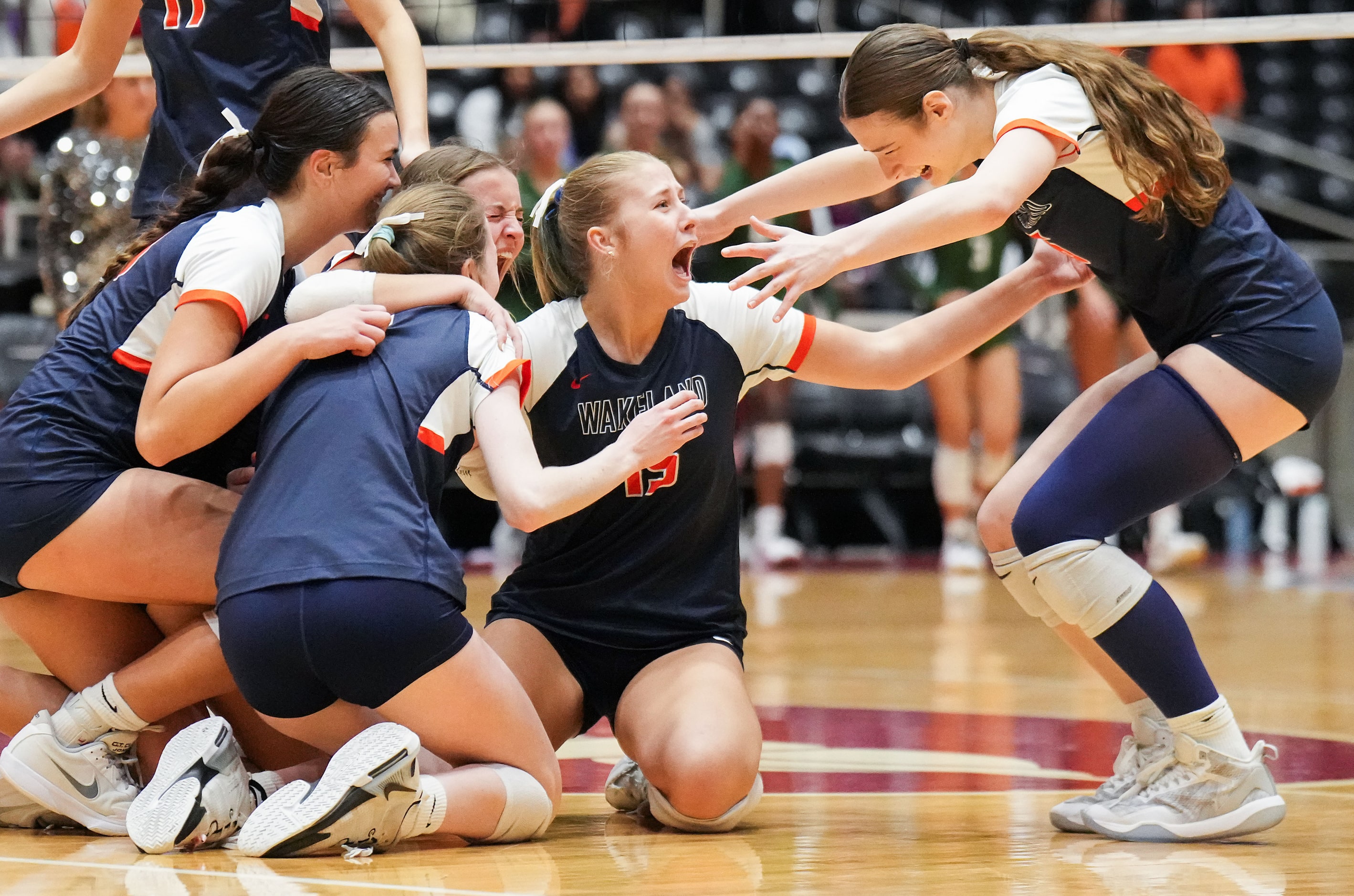 Frisco Wakeland's Abby Parkinson (15) and Hannah Lee (right) celebrates with teammates after...