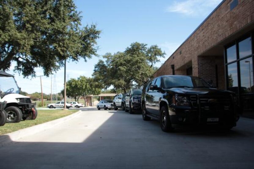 Carrollton Police Department vehicles are parked outside the building with no barrier...