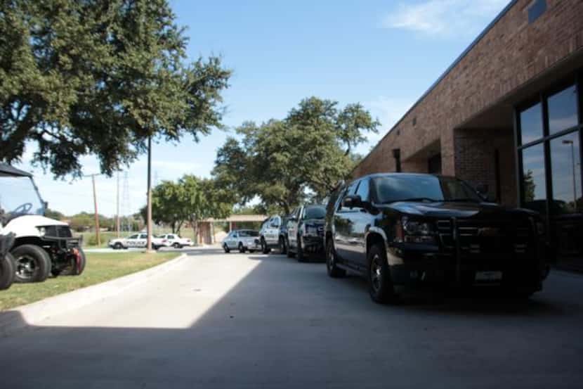 Carrollton Police Department vehicles are parked outside the building with no barrier...