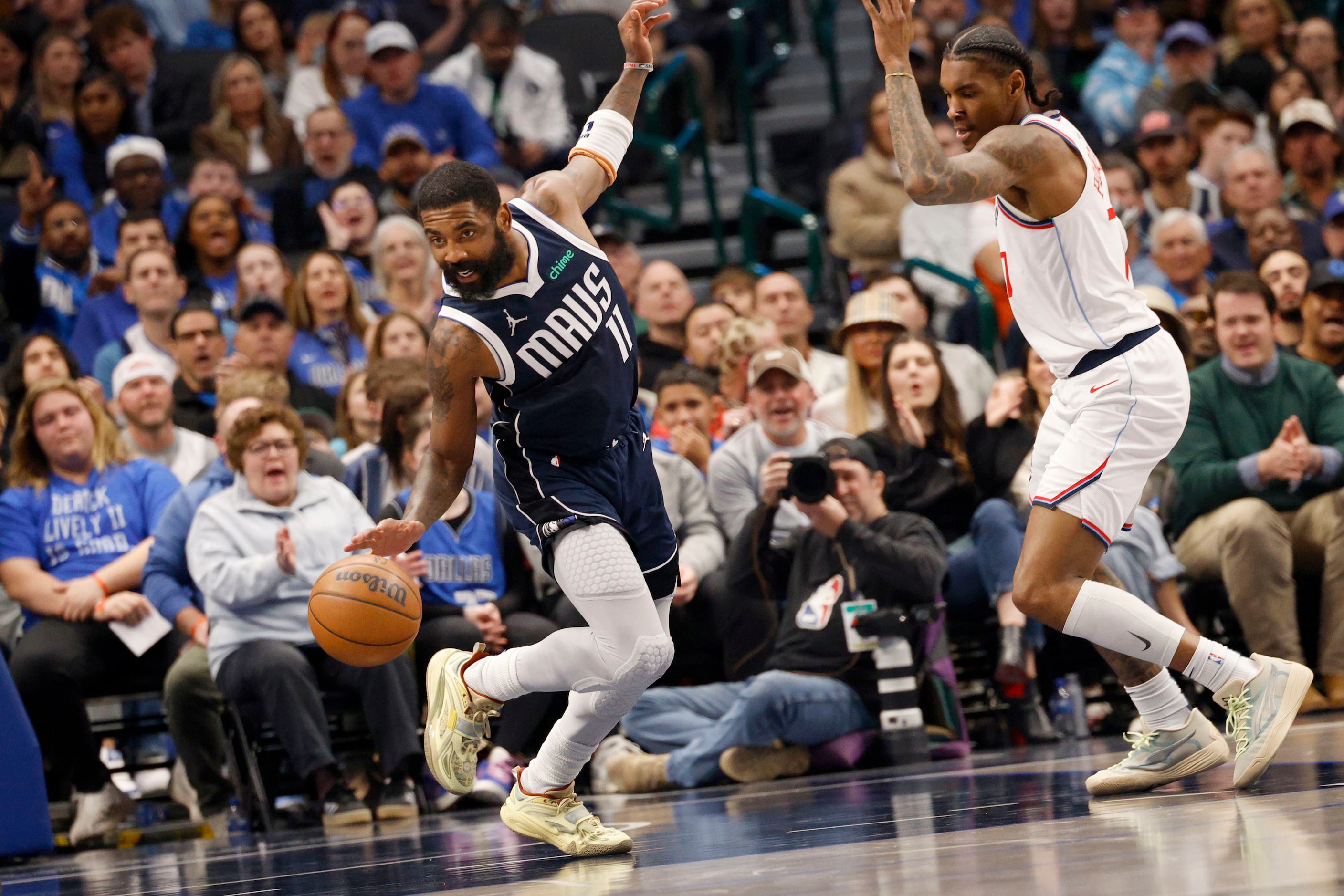 Dallas Mavericks guard Kyrie Irving (11) keeps the ball away from LA Clippers guard Kevin...