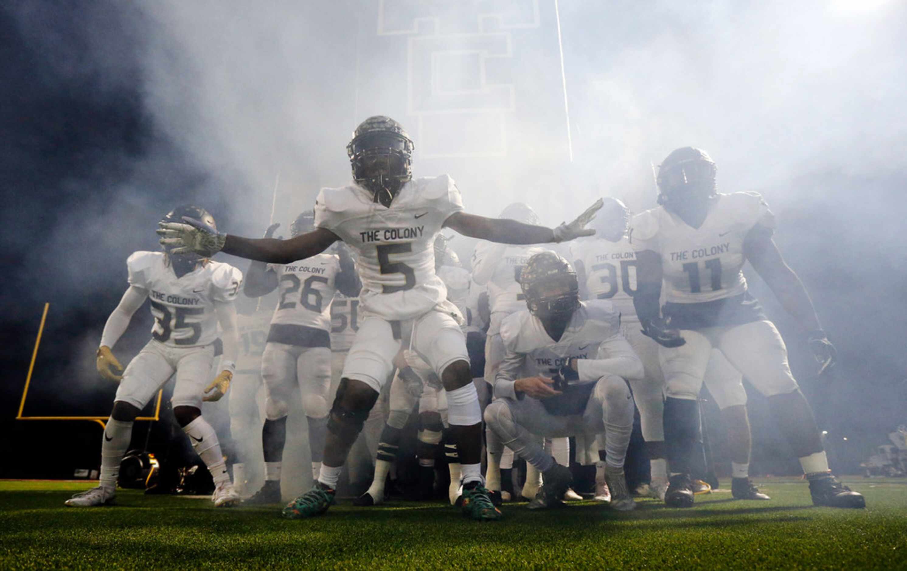 The Colony's Denoreon Beasley (5) gets his teammates fired up before taking the field to...