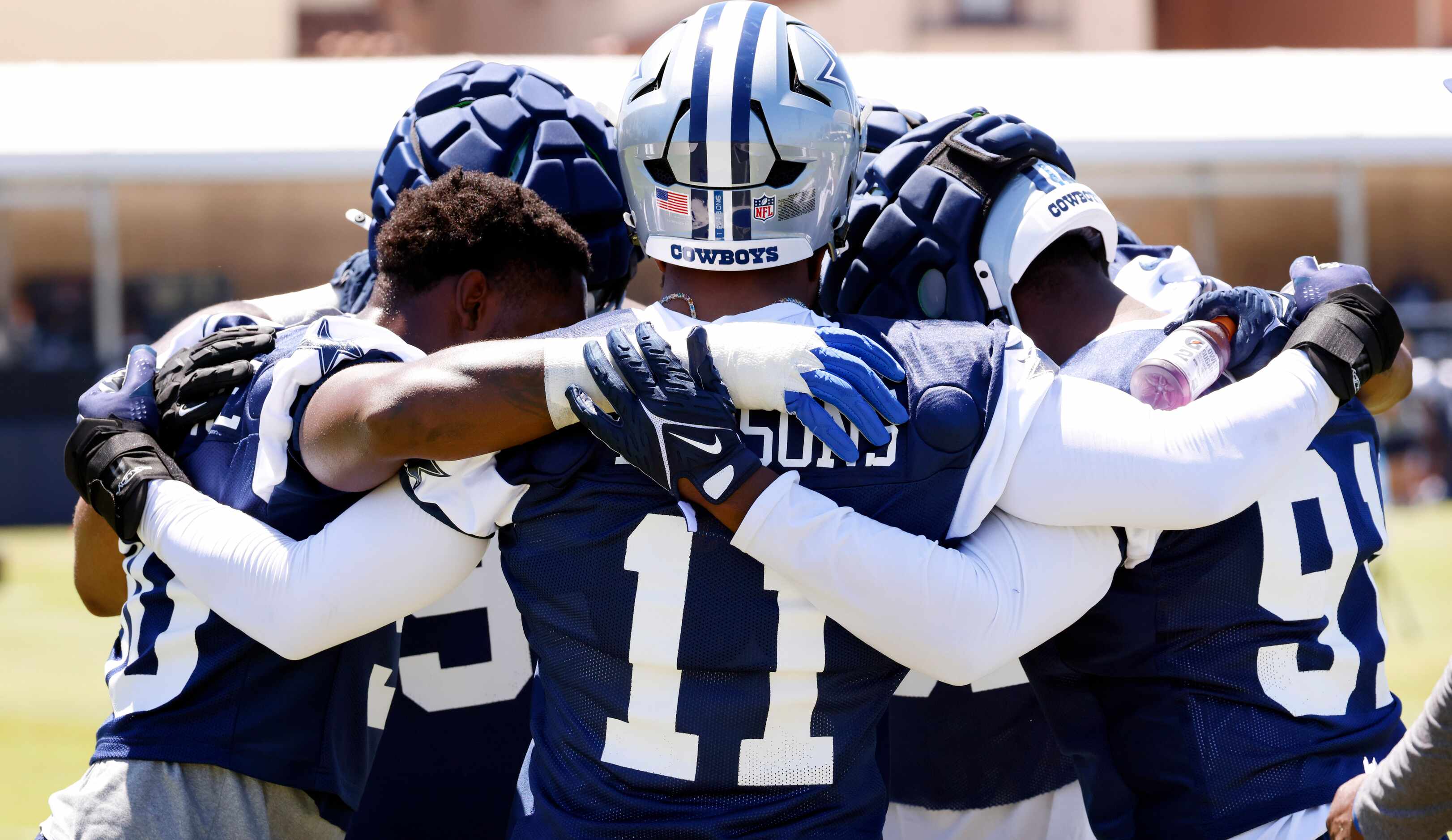 Dallas Cowboys linebacker Micah Parsons (11) and the defensive ends huddle following a...