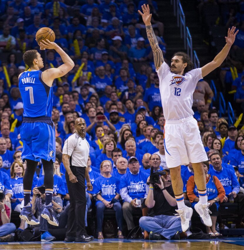 Dallas Mavericks forward Dwight Powell (7) goes up for a shot over Oklahoma City Thunder...