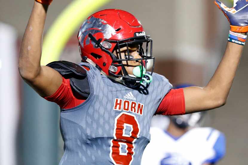 Mesquite Horn High Reggie Roberson (8) signals his touchdown catch during the first half of...