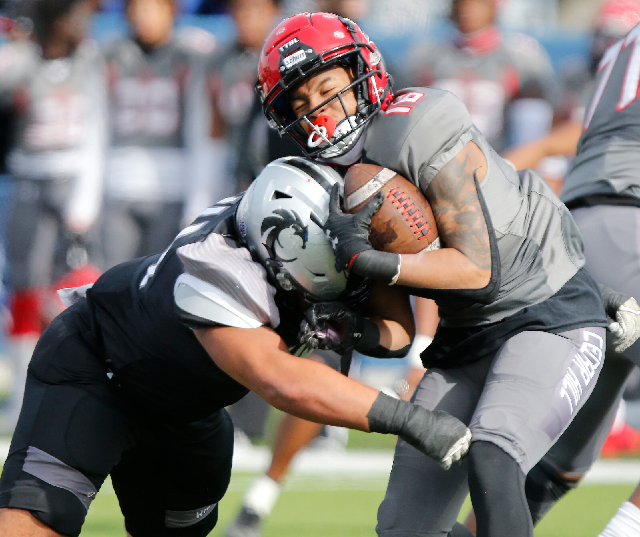 Cedar Hill High School wide receiver Jaiden Callahan (16) is hit by Denton Guyer High School...