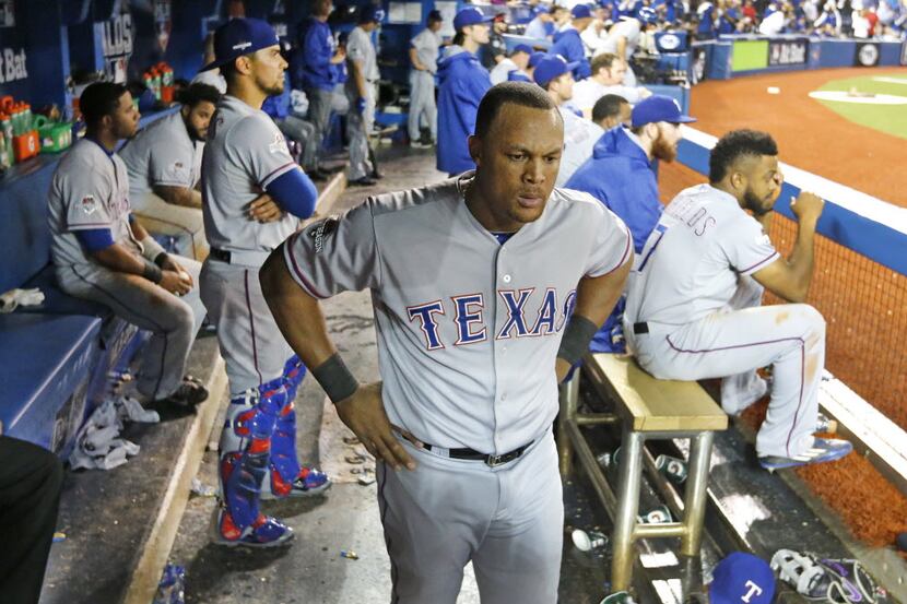 Texas Rangers third baseman Adrian Beltre (29) stands in the dugout as the Rangers are...