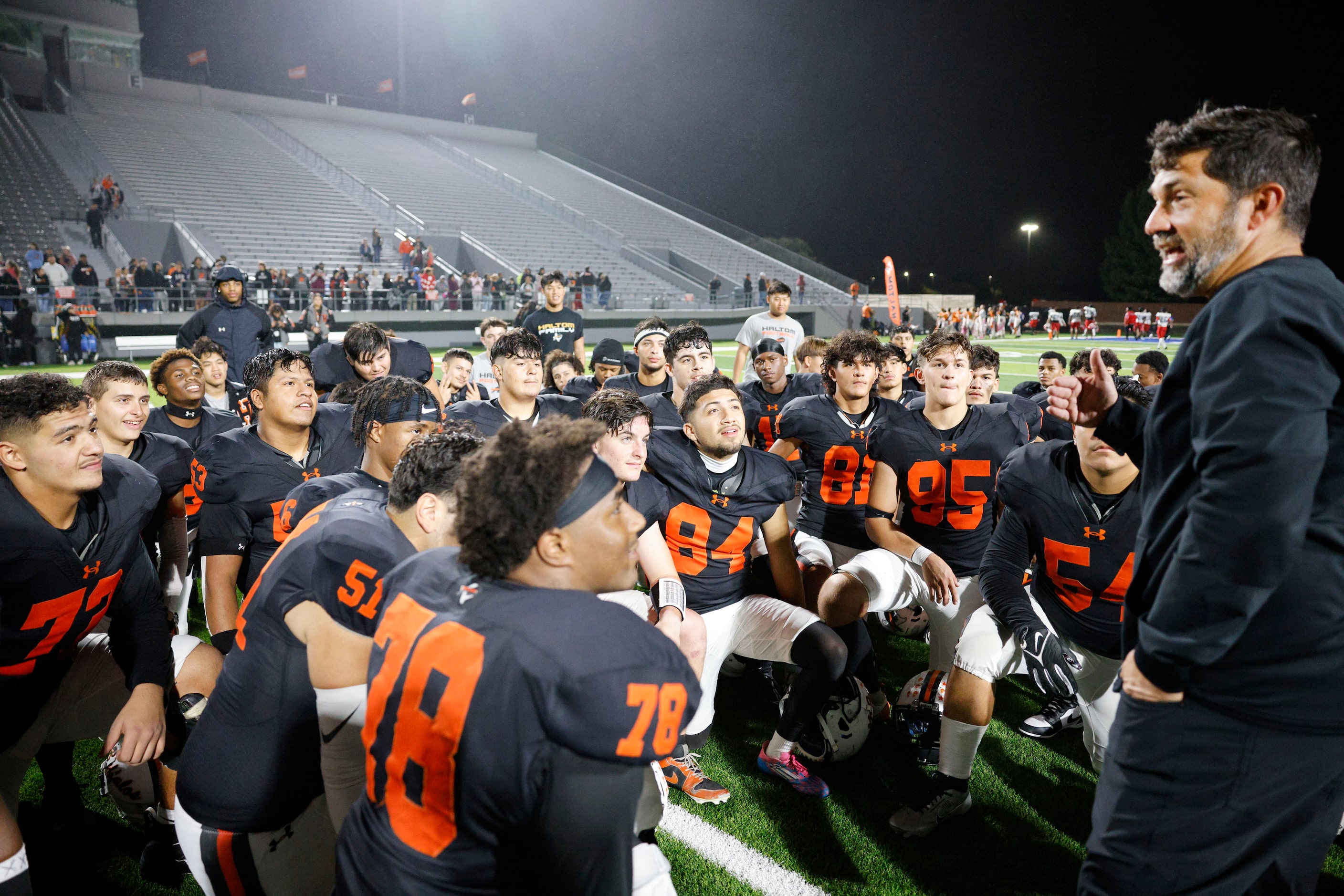 Haltom head football coach Jason Tucker, far right, speaks to his players after their 42-8...