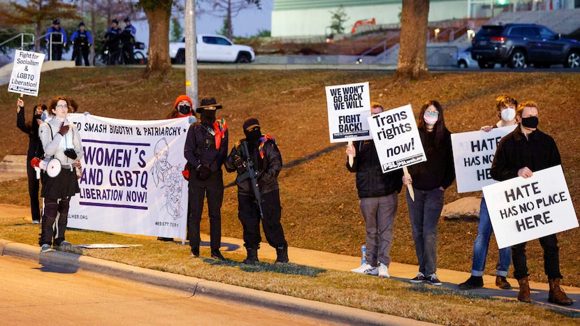 Armed leftists and members of The Party for Socialism and Liberation carry signs supporting...