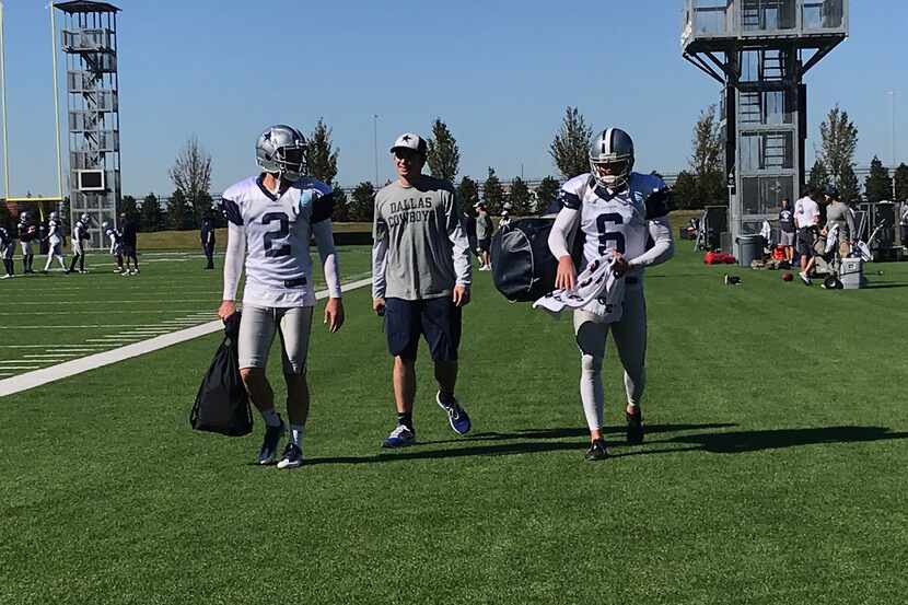 New Cowboys kicker Mike Nugent (left, 2) walks off the field with punter Chris Jones (6) at...