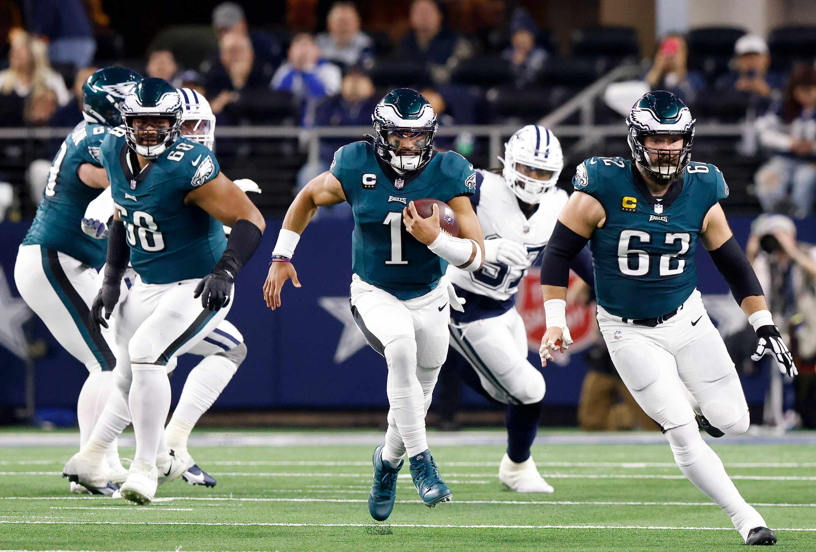 Philadelphia Eagles quarterback Jalen Hurts (1) takes off running against the Dallas Cowboys...
