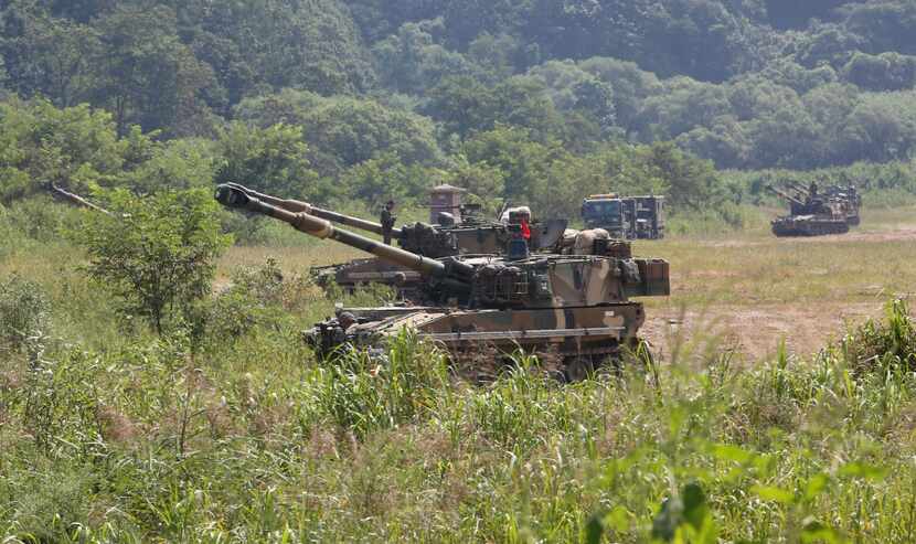 South Korean army soldiers take positions with their K-55 self-propelled howitzers during a...