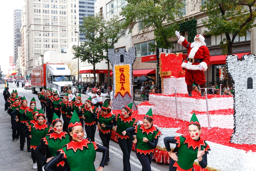 Santa Claus waved to the crowd along Commerce Street during the Dallas Holiday Parade on...