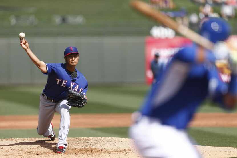 Texas Rangers' Yu Darvish pitches against the Kansas City Royals during a Cactus League game...