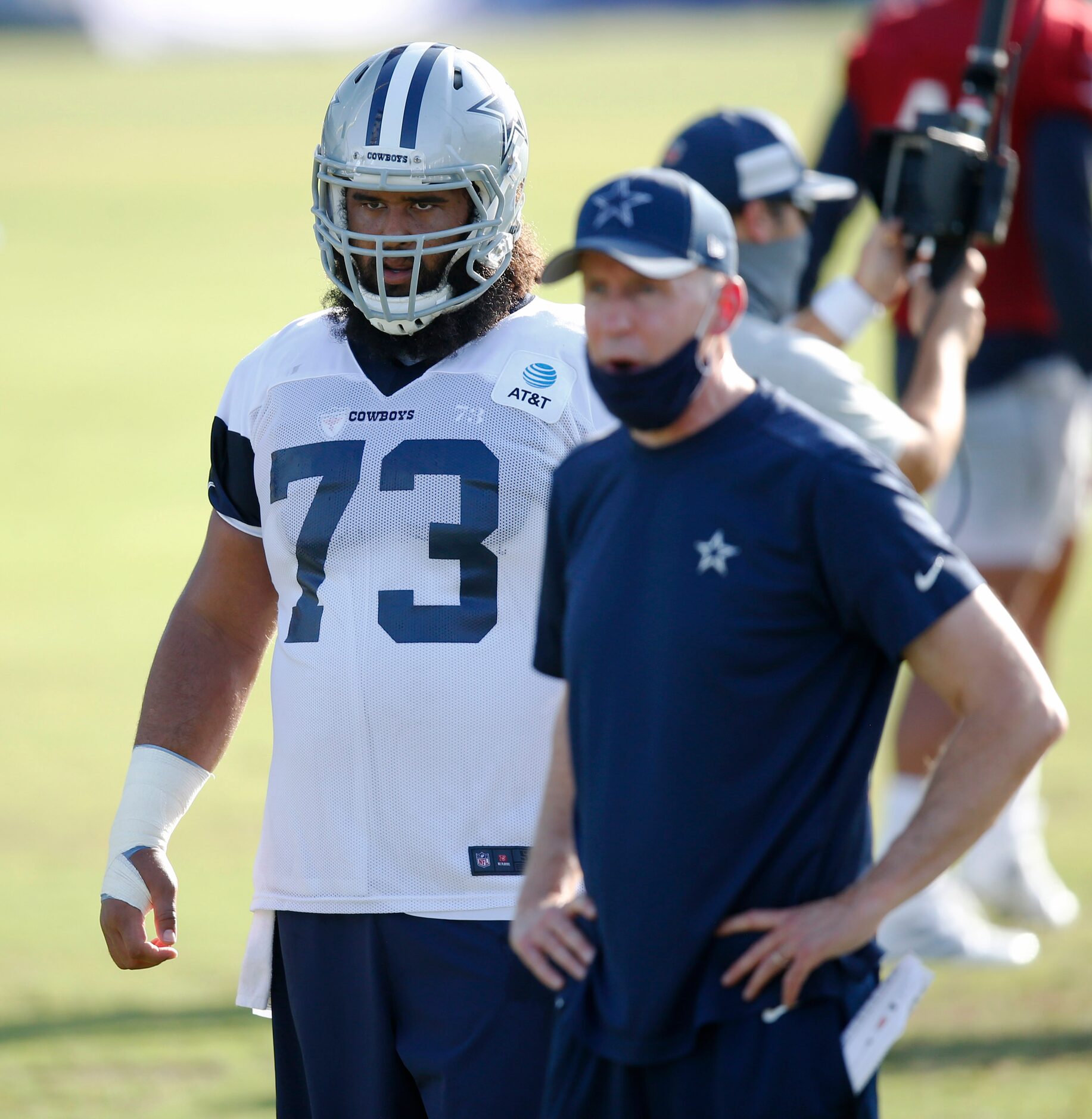 Dallas Cowboys center Joe Looney (73) watches practice during the first day of training camp...