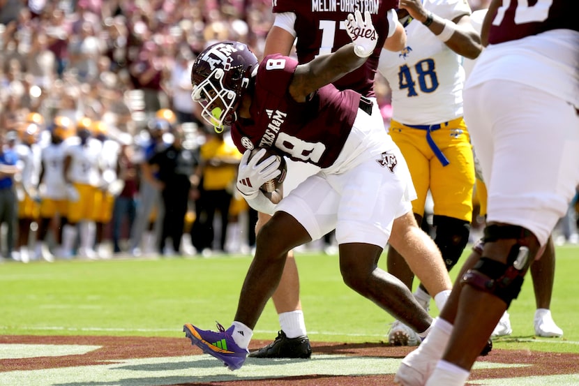 Texas A&M running back Le'Veon Moss (8) reacts after scoring a touchdown on a two-yard run...