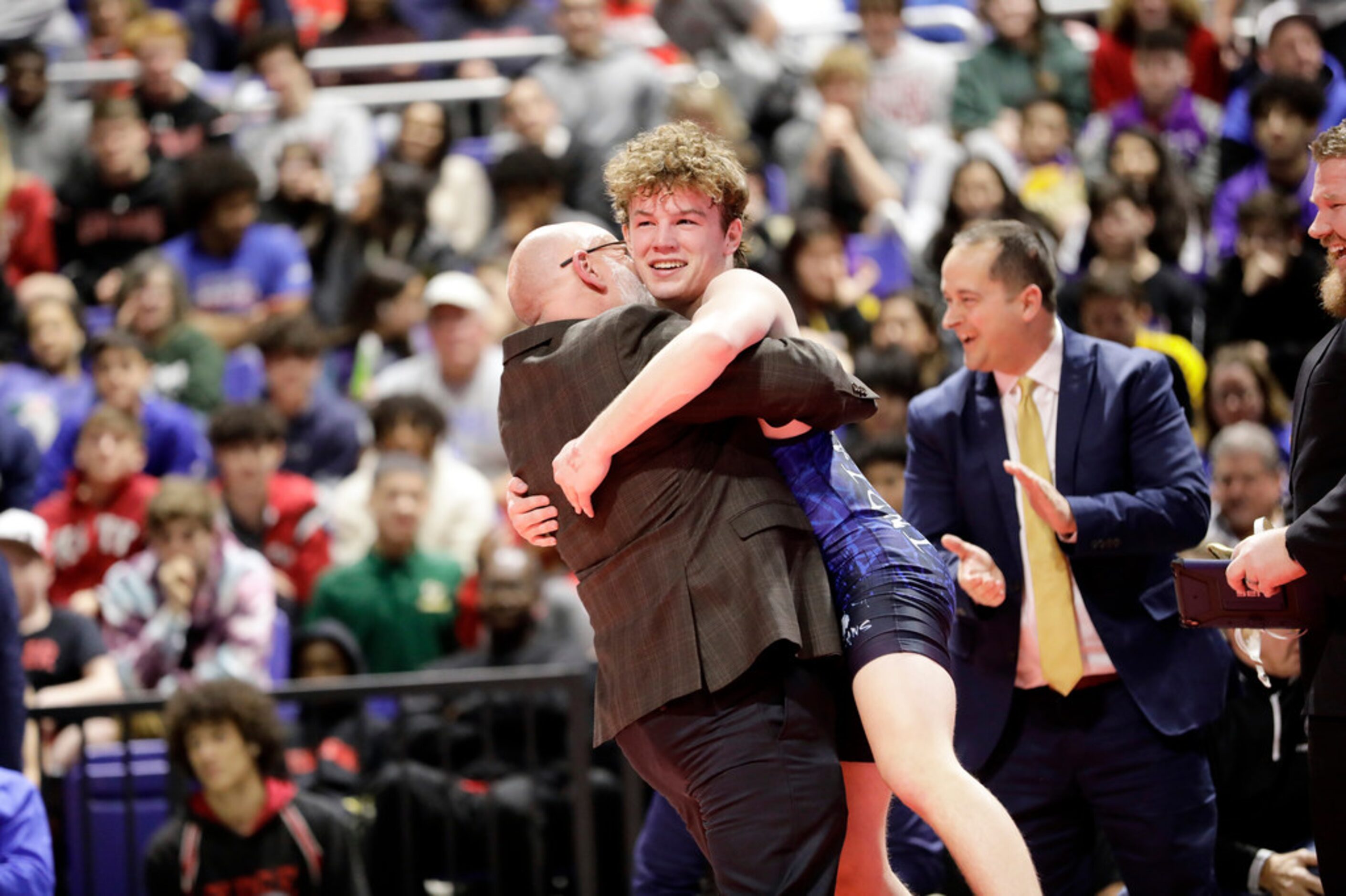 Parker Decker of Keller wrestles against Tagen Jamison of Plano West during the UIL Texas...