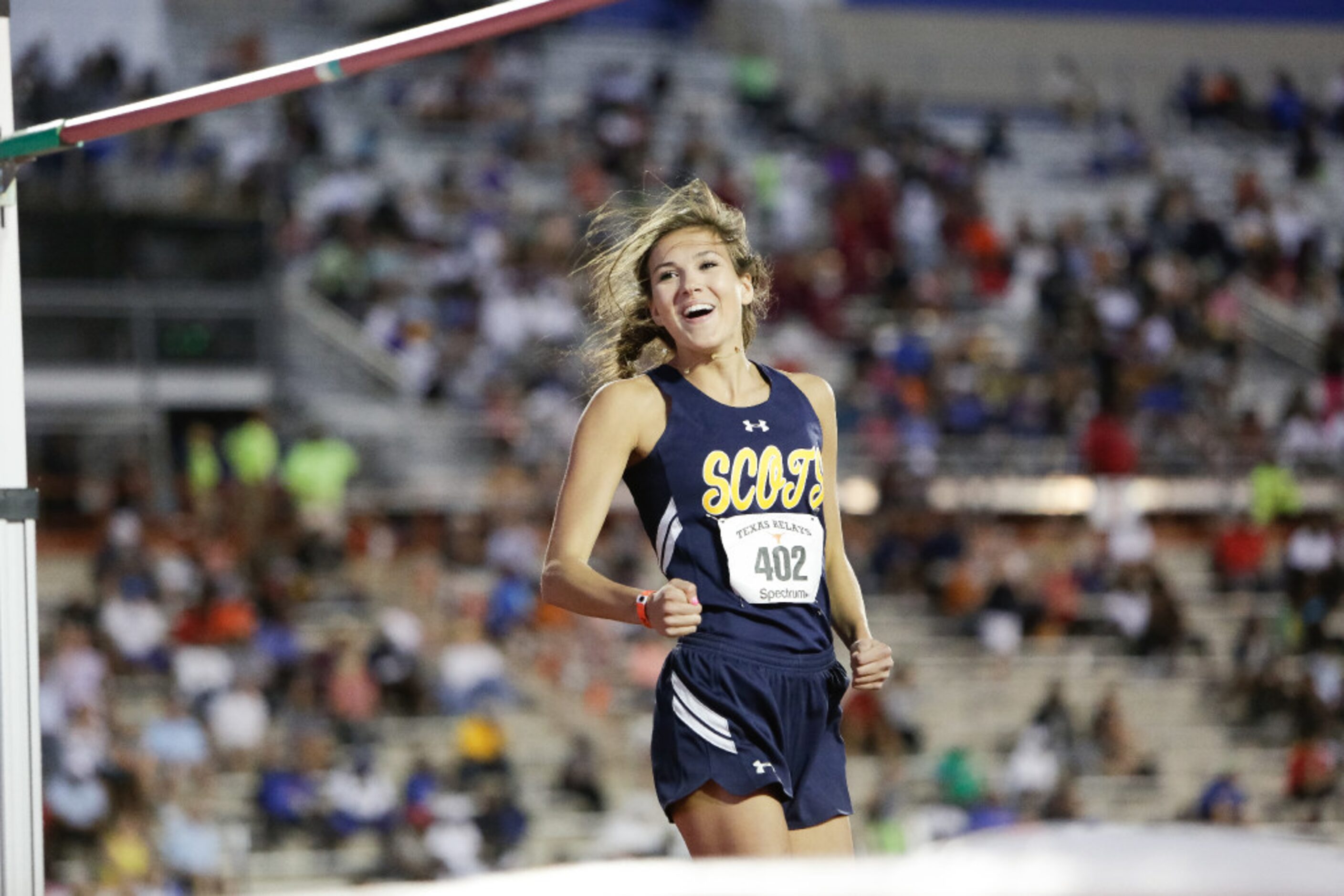 Highland Park senior Falyn Reaugh smiles after clearing the bar at a height of 6'0" during...