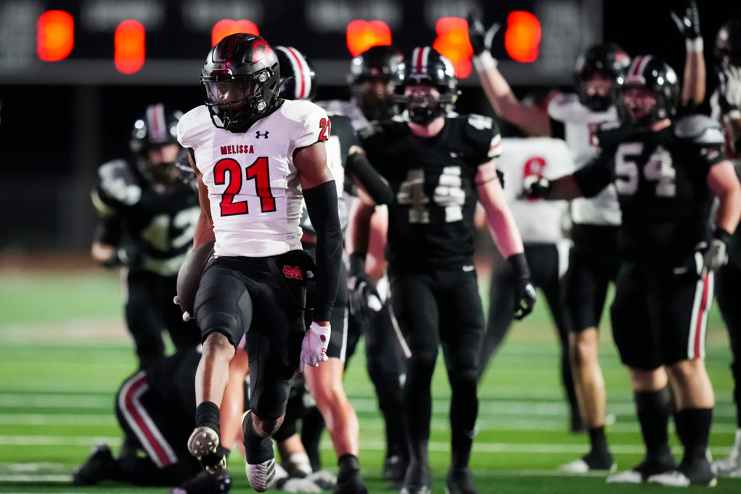 Melissa running back Nathan Adejokun (21) scores on a 4-yard touchdown run during the first...