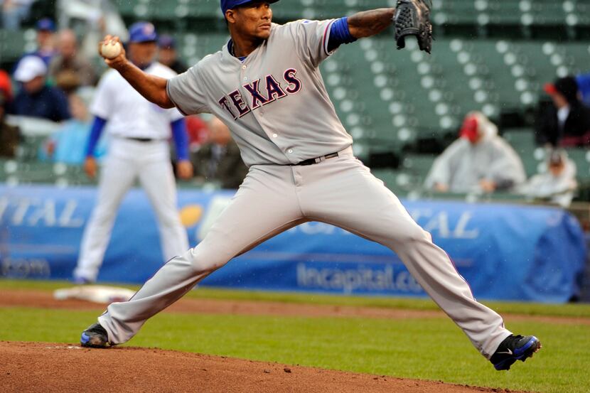 Apr 18, 2013; Chicago, IL, USA; Texas Rangers starting pitcher Alexi Ogando (41) pitches...