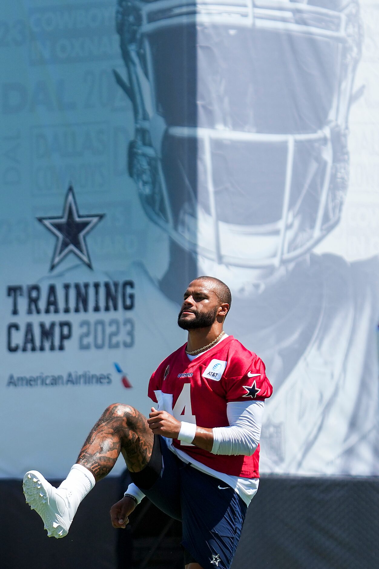 Dallas Cowboys quarterback Dak Prescott (4) stretches during the first practice of the...