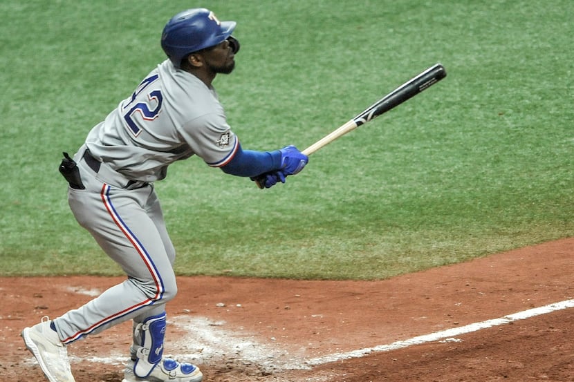 Texas Rangers' Adolis Garcia hits a two-run home run off Tampa Bay Rays reliever Cody Reed...