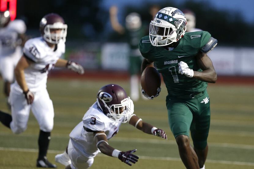 Waxahachie receiver Jalen Reagor runs the ball past Ennis cornerback Ike Walker in the first...