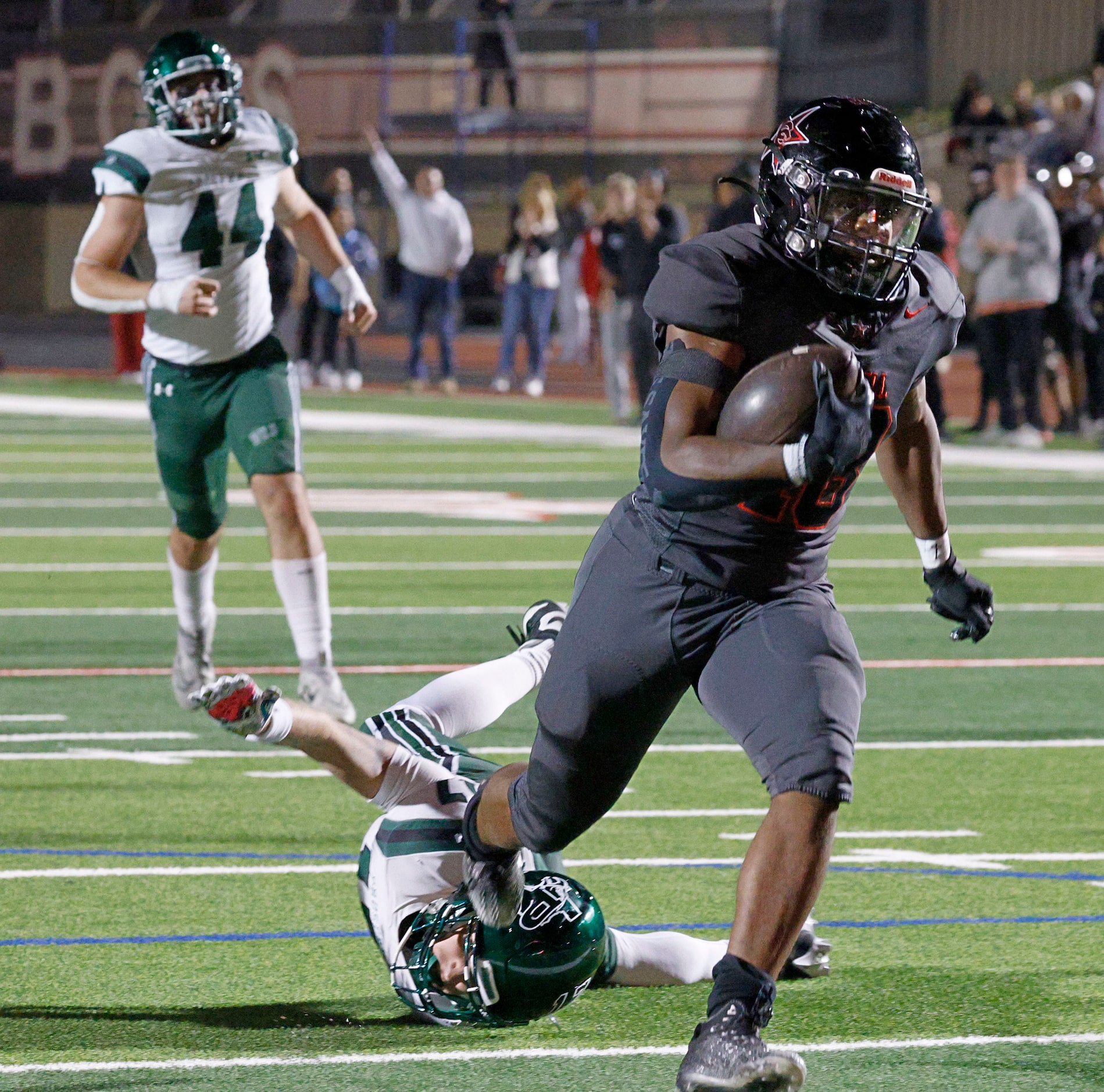 Coppell's Josh Lock (18) scores a touchdown over Prosper's Logan Thompson (17), bottom, as...