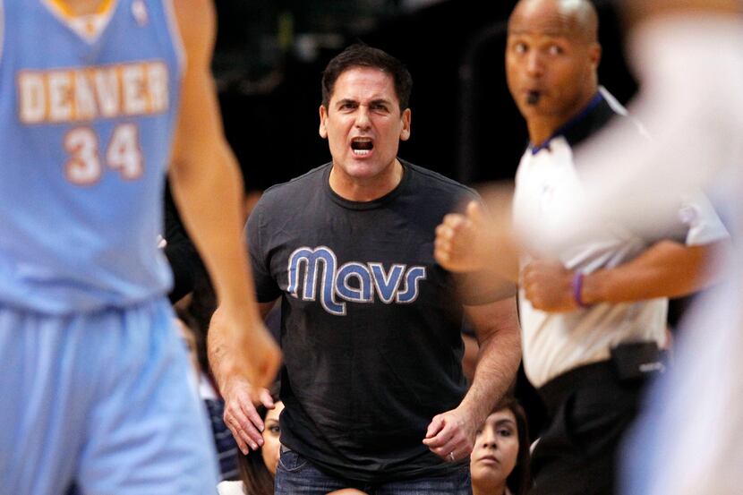 Dallas Mavericks owner Mark Cuban argues with an official about a call in a game against the...