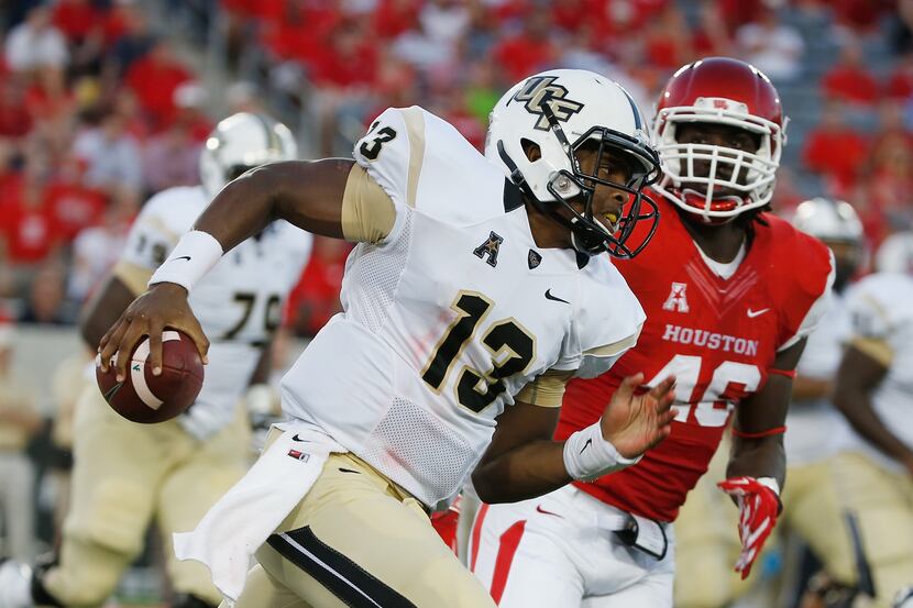 HOUSTON, TX - OCTOBER 02:  Justin Holman #13 of the UCF Knights scrambles in the first half...