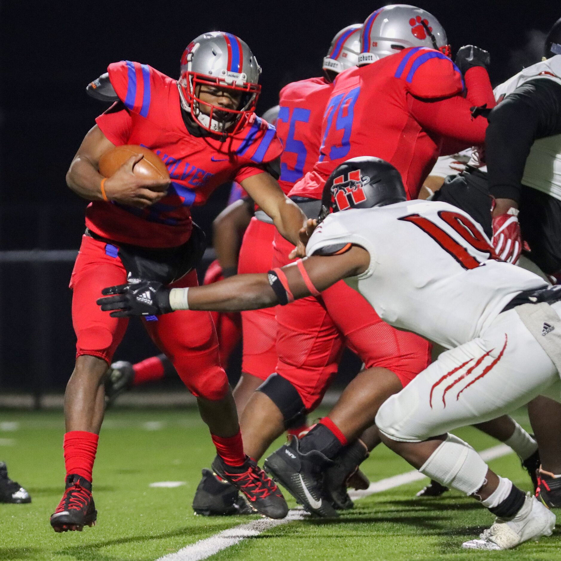 Spruce running back Shawn Hodge (22) blocks Hillcrest linebacker Damarlynn Bell (19) during...