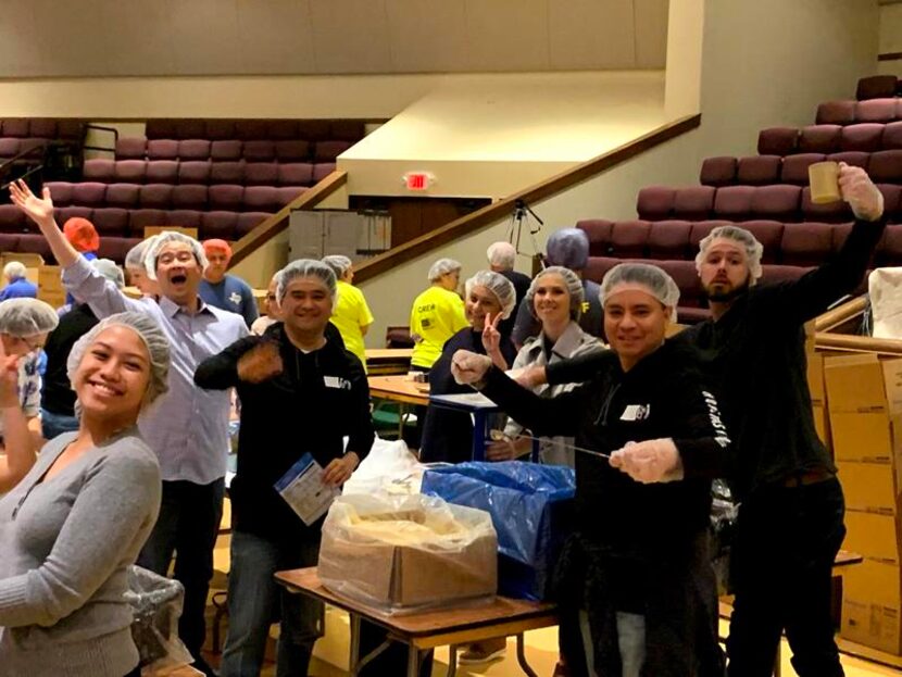 Group shot of NYL volunteers wearing hair aprons