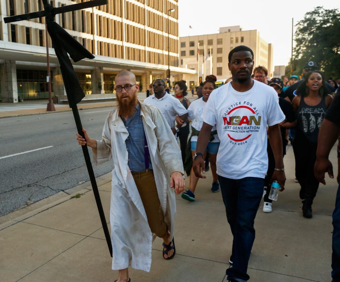 The Rev. Dr. Jeff Hood (left) and Dominique Alexander lead protesters east on Commerce...