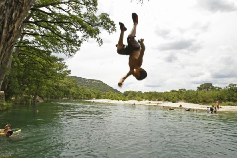 Head for the Hills -- Ralph Perez, 9, of Corpus Christi practices his backflips from a...