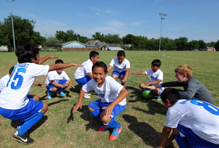 Members of the soccer team from Pershing Elementary School warmed up before a DISD...