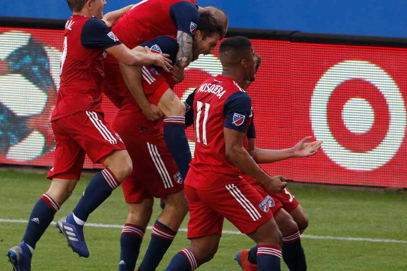 FC Dallas' Ryan Hollingshead (12), became the center of attention as he lets out a yell as...