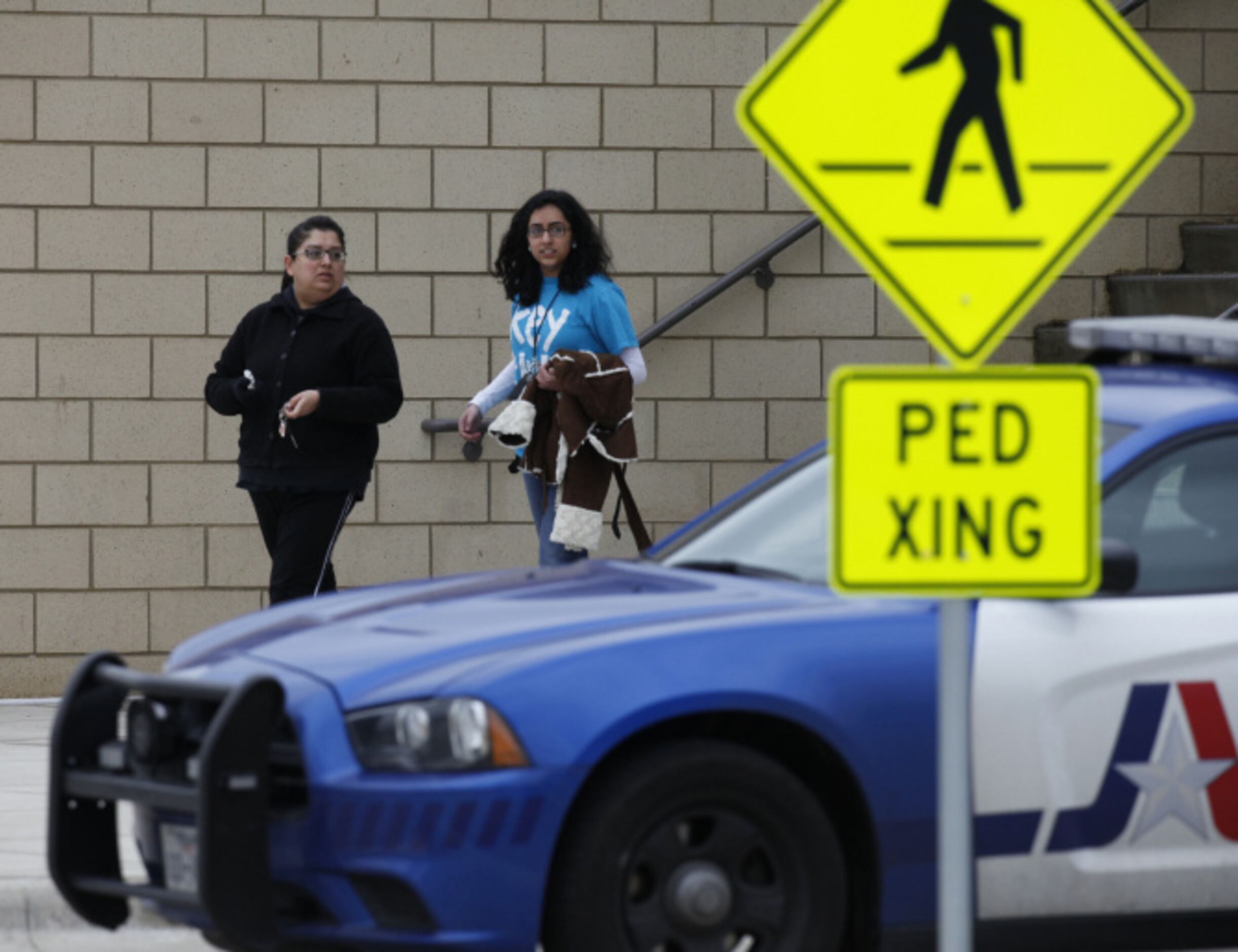 Shaista Ali, walks out of school with her daughter Sonia Ali, a sophomore, after a lockdown...