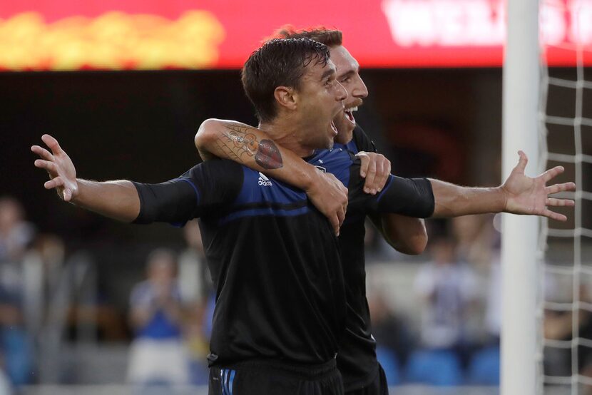 San Jose Earthquakes forward Chris Wondolowski, left, celebrates with defender Guram Kashia...