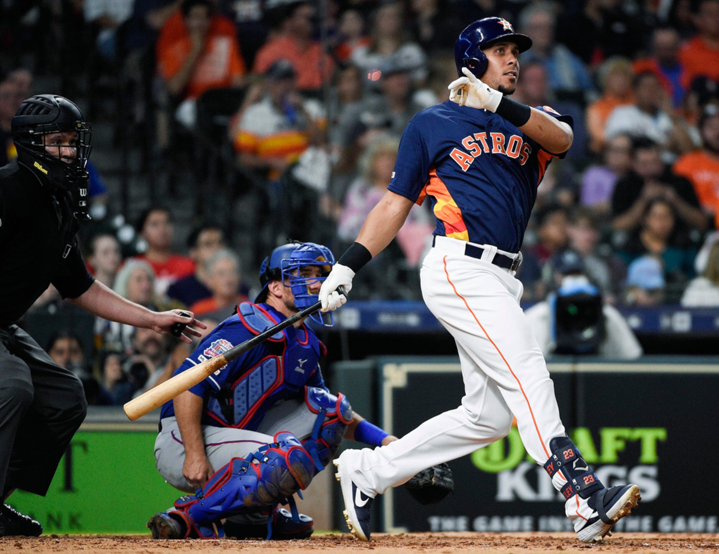 Houston Astros' Michael Brantley watches his solo home run off Texas Rangers relief pitcher...